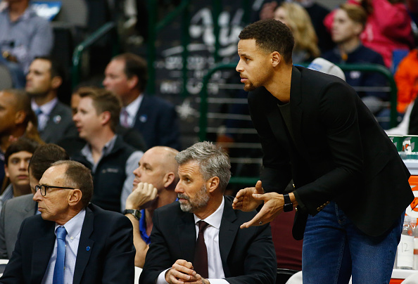 DALLAS, TX - DECEMBER 30: Stephen Curry #30 of the Golden State Warriors claps while on the bench during a game against the Dallas Mavericks at American Airlines Center on December 30, 2015 in Dallas, Texas. NOTE TO USER: User expressly acknowledges and agrees that, by downloading and or using photograph, User is consenting to the terms and conditions of the Getty Images License Agreement. (Photo by Ronald Martinez/Getty Images)
