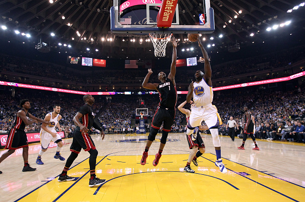 OAKLAND, CA - JANUARY 11: Draymond Green #23 of the Golden State Warriors goes up for a shot against Chris Bosh #1 of the Miami Heat at ORACLE Arena on January 11, 2016 in Oakland, California. NOTE TO USER: User expressly acknowledges and agrees that, by downloading and or using this photograph, User is consenting to the terms and conditions of the Getty Images License Agreement. (Photo by Ezra Shaw/Getty Images)