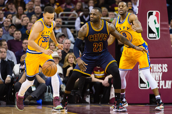 CLEVELAND, OH - JANUARY 18: Stephen Curry #30 drives down court after stealing from LeBron James #23 of the Cleveland Cavaliers while under pressure from Andre Iguodala #9 of the Golden State Warriors during the first half at Quicken Loans Arena on January 18, 2016 in Cleveland, Ohio. NOTE TO USER: User expressly acknowledges and agrees that, by downloading and/or using this photograph, user is consenting to the terms and conditions of the Getty Images License Agreement. Mandatory copyright notice. (Photo by Jason Miller/Getty Images)