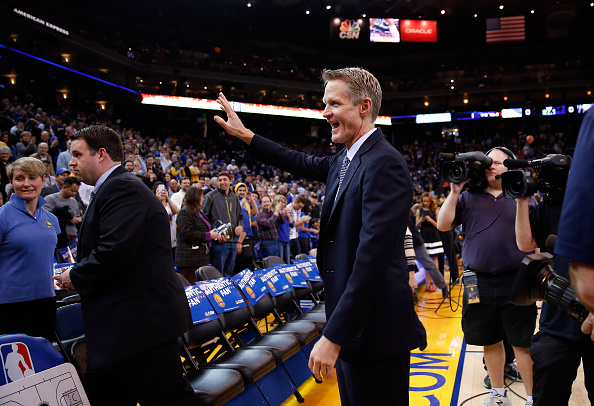OAKLAND, CA - JANUARY 22: Head coach Steve Kerr of the Golden State Warriors waves to the crowd before their game against the Indiana Pacers at ORACLE Arena on January 22, 2016 in Oakland, California. This is Kerr's first game of the season. NOTE TO USER: User expressly acknowledges and agrees that, by downloading and or using this photograph, User is consenting to the terms and conditions of the Getty Images License Agreement. (Photo by Ezra Shaw/Getty Images)