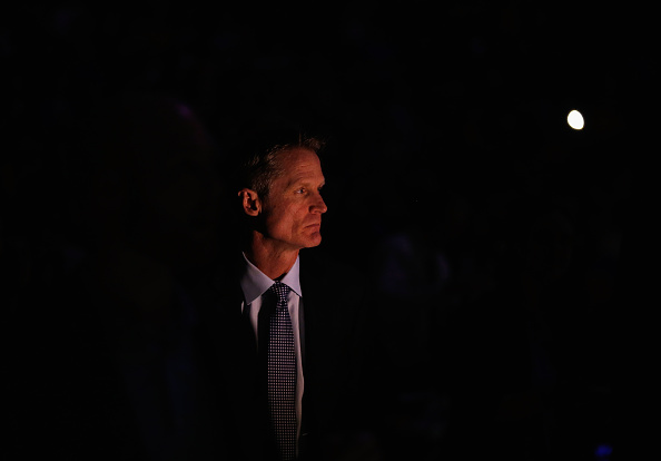 OAKLAND, CA - JANUARY 22: Head coach Steve Kerr of the Golden State Warriors stands for player introductions before their game against the Indiana Pacers at ORACLE Arena on January 22, 2016 in Oakland, California. This is Kerr's first game of the season. NOTE TO USER: User expressly acknowledges and agrees that, by downloading and or using this photograph, User is consenting to the terms and conditions of the Getty Images License Agreement. (Photo by Ezra Shaw/Getty Images)