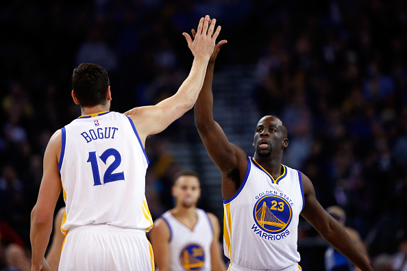 OAKLAND, CA - JANUARY 27: Draymond Green #23 high-fives Andrew Bogut #12 of the Golden State Warriors during their game against the Dallas Mavericks at ORACLE Arena on January 27, 2016 in Oakland, California. NOTE TO USER: User expressly acknowledges and agrees that, by downloading and or using this photograph, User is consenting to the terms and conditions of the Getty Images License Agreement. (Photo by Ezra Shaw/Getty Images)
