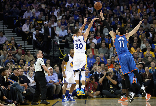 OAKLAND, CA - MARCH 03: Stephen Curry #30 of the Golden State Warriors shoots a three-pointer over Enes Kanter #11 of the Oklahoma City Thunder at ORACLE Arena on March 3, 2016 in Oakland, California. NOTE TO USER: User expressly acknowledges and agrees that, by downloading and or using this photograph, User is consenting to the terms and conditions of the Getty Images License Agreement. (Photo by Ezra Shaw/Getty Images)