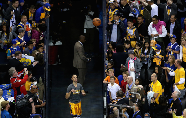 OAKLAND, CA - MARCH 29: Stephen Curry #30 of the Golden State Warriors shoots his ceremonial shot from the hallway before their game against the Washington Wizards at ORACLE Arena on March 29, 2016 in Oakland, California. NOTE TO USER: User expressly acknowledges and agrees that, by downloading and or using this photograph, User is consenting to the terms and conditions of the Getty Images License Agreement. (Photo by Ezra Shaw/Getty Images)