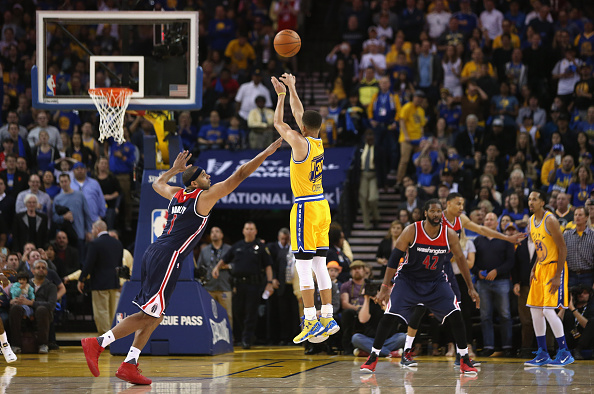 OAKLAND, CA - MARCH 29: Stephen Curry #30 of the Golden State Warriors shoots a three-point basket over Jared Dudley #1 of the Washington Wizards at ORACLE Arena on March 29, 2016 in Oakland, California. NOTE TO USER: User expressly acknowledges and agrees that, by downloading and or using this photograph, User is consenting to the terms and conditions of the Getty Images License Agreement. (Photo by Ezra Shaw/Getty Images)