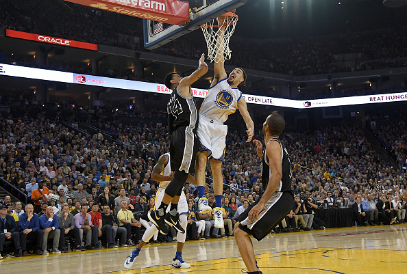 OAKLAND, CALIFORNIA - APRIL 07: Klay Thompson #11 of the Golden State Warriors misses a slam dunk over Danny Green #14 of the San Antonio Spurs in the first quarter of an NBA Basketball game at ORACLE Arena on April 7, 2016 in Oakland, California. NOTE TO USER: User expressly acknowledges and agrees that, by downloading and or using this photograph, User is consenting to the terms and conditions of the Getty Images License Agreement. (Photo by Thearon W. Henderson/Getty Images)