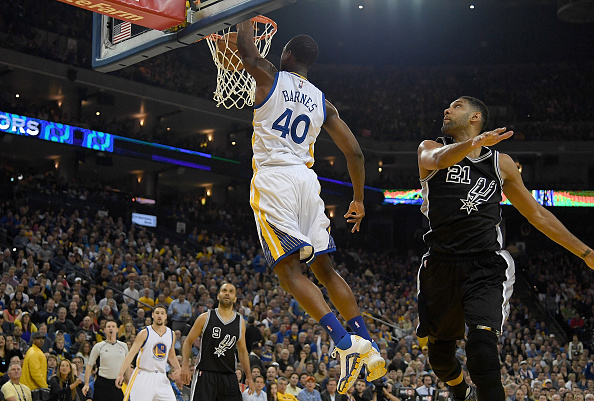 OAKLAND, CALIFORNIA - APRIL 07: Harrison Barnes #40 of the Golden State Warriors slam dunks the ball over Tim Duncan #21 of the San Antonio Spurs in the first quarter of an NBA Basketball game at ORACLE Arena on April 7, 2016 in Oakland, California. NOTE TO USER: User expressly acknowledges and agrees that, by downloading and or using this photograph, User is consenting to the terms and conditions of the Getty Images License Agreement. (Photo by Thearon W. Henderson/Getty Images)