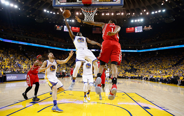 OAKLAND, CA - APRIL 27: Ian Clark #21 of the Golden State Warriors goes up for a shot against Trevor Ariza #1 of the Houston Rockets in Game Five of the Western Conference Quarterfinals during the 2016 NBA Playoffs at ORACLE Arena on April 27, 2016 in Oakland, California. NOTE TO USER: User expressly acknowledges and agrees that, by downloading and or using this photograph, user is consenting to the terms and conditions of Getty Images License Agreement. (Photo by Ezra Shaw/Getty Images)