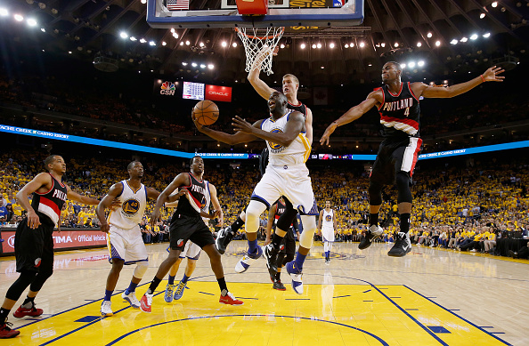 OAKLAND, CA - MAY 03: Draymond Green #23 of the Golden State Warriors goes up for a shot against Mason Plumlee #24 and Maurice Harkless #4 of the Portland Trail Blazers during Game Two of the Western Conference Semifinals during the 2016 NBA Playoffs on May 3, 2016 at Oracle Arena in Oakland, California. NOTE TO USER: User expressly acknowledges and agrees that, by downloading and or using this photograph, User is consenting to the terms and conditions of the Getty Images License Agreement. (Photo by Ezra Shaw/Getty Images)