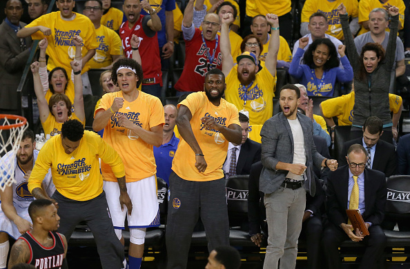 OAKLAND, CA - MAY 03: (R-L) Stephen Curry #30, Festus Ezeli #31 and Anderson Varejao #18 of the Golden State Warriors react on the bench during their game against the Portland Trail Blazers during Game Two of the Western Conference Semifinals during the 2016 NBA Playoffs on May 3, 2016 at Oracle Arena in Oakland, California. NOTE TO USER: User expressly acknowledges and agrees that, by downloading and or using this photograph, User is consenting to the terms and conditions of the Getty Images License Agreement. (Photo by Ezra Shaw/Getty Images)