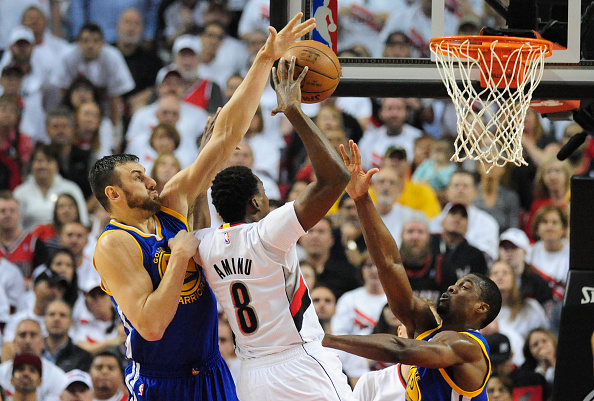 PORTLAND, OR - MAY 9: Andrew Bogut #12 of the Golden State Warriors blocks the shot of Al-Farouq Aminu #8 of the Portland Trail Blazers during the first quarter of Game Four of the Western Conference Semifinals during the 2016 NBA Playoffs at the Moda Center on May 9, 2016 in Portland, Oregon. NOTE TO USER: User expressly acknowledges and agrees that by downloading and/or using this photograph, user is consenting to the terms and conditions of the Getty Images License Agreement. (Photo by Steve Dykes/Getty Images)
