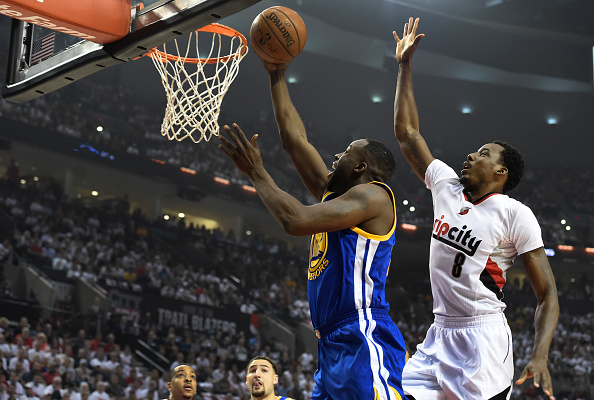 PORTLAND, OR - MAY 9: Draymond Green #23 of the Golden State Warriors drive to the basket on Al-Farouq Aminu #8 of the Portland Trail Blazers during the first quarter of Game Four of the Western Conference Semifinals during the 2016 NBA Playoffs at the Moda Center on May 9, 2016 in Portland, Oregon. NOTE TO USER: User expressly acknowledges and agrees that by downloading and/or using this photograph, user is consenting to the terms and conditions of the Getty Images License Agreement. (Photo by Steve Dykes/Getty Images)