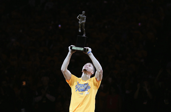 OAKLAND, CA - MAY 11: Stephen Curry #30 of the Golden State Warriors lifts up his MVP trophy before their game against the Portland Trail Blazers in Game Five of the Western Conference Semifinals during the 2016 NBA Playoffs on May 11, 2016 at Oracle Arena in Oakland, California. NOTE TO USER: User expressly acknowledges and agrees that, by downloading and or using this photograph, User is consenting to the terms and conditions of the Getty Images License Agreement. (Photo by Ezra Shaw/Getty Images)