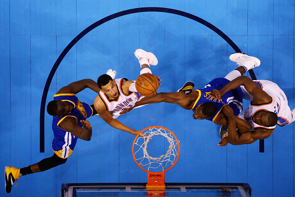 OKLAHOMA CITY, OK - MAY 22: Andre Roberson #21 of the Oklahoma City Thunder shoots against Draymond Green #23 of the Golden State Warriors in the first half in game three of the Western Conference Finals during the 2016 NBA Playoffs at Chesapeake Energy Arena on May 22, 2016 in Oklahoma City, Oklahoma. NOTE TO USER: User expressly acknowledges and agrees that, by downloading and or using this photograph, User is consenting to the terms and conditions of the Getty Images License Agreement. (Photo by Ronald Martinez/Getty Images)