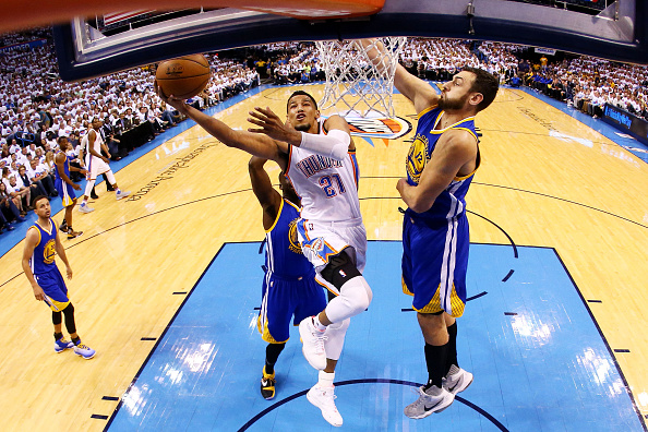 OKLAHOMA CITY, OK - MAY 24: Andre Roberson #21 of the Oklahoma City Thunder shoots against Andrew Bogut #12 of the Golden State Warriors in the first half in game four of the Western Conference Finals during the 2016 NBA Playoffs at Chesapeake Energy Arena on May 24, 2016 in Oklahoma City, Oklahoma. NOTE TO USER: User expressly acknowledges and agrees that, by downloading and or using this photograph, User is consenting to the terms and conditions of the Getty Images License Agreement. (Photo by Ronald Martinez/Getty Images)