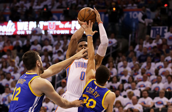 OKLAHOMA CITY, OK - MAY 24: Russell Westbrook #0 of the Oklahoma City Thunder shoots against Stephen Curry #30 and Andrew Bogut #12 of the Golden State Warriors in the third quarter in game four of the Western Conference Finals during the 2016 NBA Playoffs at Chesapeake Energy Arena on May 24, 2016 in Oklahoma City, Oklahoma. NOTE TO USER: User expressly acknowledges and agrees that, by downloading and or using this photograph, User is consenting to the terms and conditions of the Getty Images License Agreement. (Photo by Ronald Martinez/Getty Images)