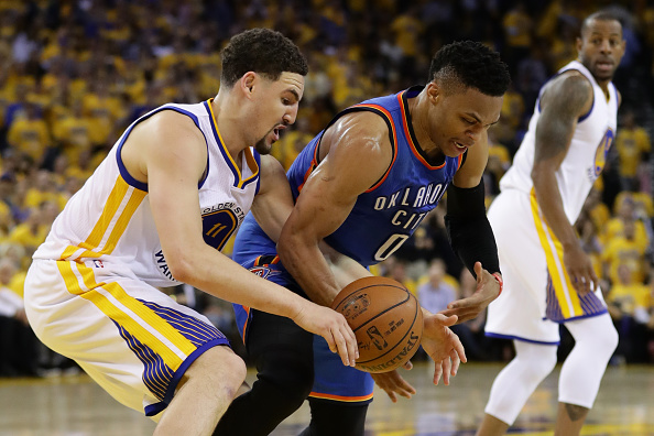 OAKLAND, CA - MAY 26: Klay Thompson #11 of the Golden State Warriors and Russell Westbrook #0 of the Oklahoma City Thunder fight for a loose ball during Game Five of the Western Conference Finals during the 2016 NBA Playoffs at ORACLE Arena on May 26, 2016 in Oakland, California. (Photo by Ezra Shaw/Getty Images)