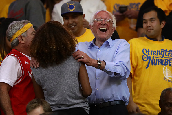 OAKLAND, CA - MAY 30: Democratic presidential candidate Bernie Sanders greets fans at Game Seven of the Western Conference Finals between the Golden State Warriors and the Oklahoma City Thunder during the 2016 NBA Playoffs at ORACLE Arena on May 30, 2016 in Oakland, California. NOTE TO USER: User expressly acknowledges and agrees that, by downloading and or using this photograph, User is consenting to the terms and conditions of the Getty Images License Agreement. (Photo by Ezra Shaw/Getty Images)