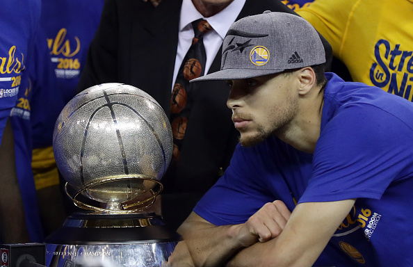OAKLAND, CA - MAY 30: Stephen Curry #30 of the Golden State Warriors poses with the Western Conference Trophy they beat the Oklahoma City Thunder in Game Seven of the Western Conference Finals during the 2016 NBA Playoffs at ORACLE Arena on May 30, 2016 in Oakland, California. NOTE TO USER: User expressly acknowledges and agrees that, by downloading and or using this photograph, User is consenting to the terms and conditions of the Getty Images License Agreement. (Photo by Ezra Shaw/Getty Images)