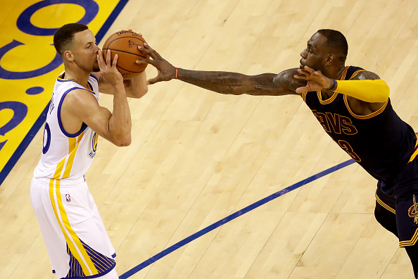 OAKLAND, CA - JUNE 02: Stephen Curry #30 of the Golden State Warriors shoots as LeBron James #23 of the Cleveland Cavaliers tries to block the shot in the first half in Game 1 of the 2016 NBA Finals at ORACLE Arena on June 2, 2016 in Oakland, California. NOTE TO USER: User expressly acknowledges and agrees that, by downloading and or using this photograph, User is consenting to the terms and conditions of the Getty Images License Agreement. (Photo by Ezra Shaw/Getty Images)