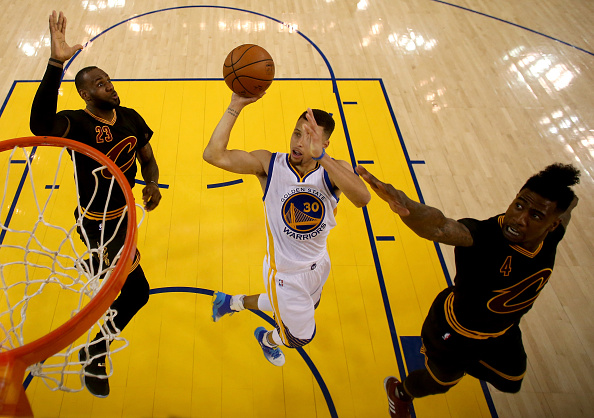OAKLAND, CA - JUNE 13: Stephen Curry #30 of the Golden State Warriors goes up for a shot between LeBron James #23 and Iman Shumpert #4 of the Cleveland Cavaliers in the first half in Game 5 of the 2016 NBA Finals at ORACLE Arena on June 13, 2016 in Oakland, California. NOTE TO USER: User expressly acknowledges and agrees that, by downloading and or using this photograph, User is consenting to the terms and conditions of the Getty Images License Agreement. (Photo by Ezra Shaw/Getty Images)