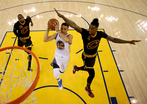 OAKLAND, CA - JUNE 13: Stephen Curry #30 of the Golden State Warriors goes up for a shot between LeBron James #23 and Iman Shumpert #4 of the Cleveland Cavaliers in the first half in Game 5 of the 2016 NBA Finals at ORACLE Arena on June 13, 2016 in Oakland, California. NOTE TO USER: User expressly acknowledges and agrees that, by downloading and or using this photograph, User is consenting to the terms and conditions of the Getty Images License Agreement. (Photo by Ezra Shaw/Getty Images)