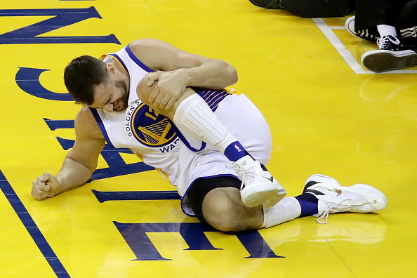 OAKLAND, CA - JUNE 13: Andrew Bogut #12 of the Golden State Warriors holds his knee in pain after sustaining an injury during the third quarter against the Cleveland Cavaliers in Game 5 of the 2016 NBA Finals at ORACLE Arena on June 13, 2016 in Oakland, California. NOTE TO USER: User expressly acknowledges and agrees that, by downloading and or using this photograph, User is consenting to the terms and conditions of the Getty Images License Agreement. (Photo by Bruce Bennett/Getty Images)
