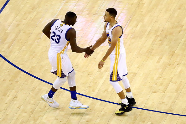 OAKLAND, CA - JUNE 19: Draymond Green #23 and Stephen Curry #30 of the Golden State Warriors react after a play against the Cleveland Cavaliers in Game 7 of the 2016 NBA Finals at ORACLE Arena on June 19, 2016 in Oakland, California. NOTE TO USER: User expressly acknowledges and agrees that, by downloading and or using this photograph, User is consenting to the terms and conditions of the Getty Images License Agreement. (Photo by Ezra Shaw/Getty Images)