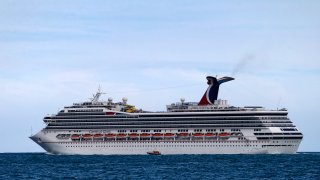 FILE - The Carnival Cruise Ship ‘Carnival Glory’ heads out to sea in the Miami harbor entrance known as Government Cut in Miami, June 2, 2018.