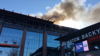 fire billowing from the roof of Globe Life Field in arlington
