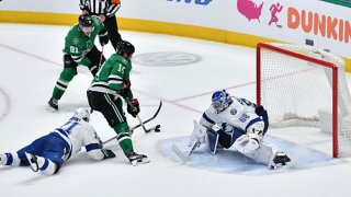 Jamie Benn #14 of the Dallas Stars slips in the game winning overtime goal against Andrei Vasilevskiy #88 of the Tampa Bay Lightning at the American Airlines Center on Jan. 27, 2020 in Dallas, Texas.