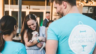 one man and two women one holds puppy