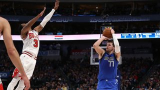 Luka Doncic #77 of the Dallas Mavericks makes a three-point shot against Shaquille Harrison #3 of the Chicago Bulls at American Airlines Center on Jan. 6, 2020 in Dallas, Texas.