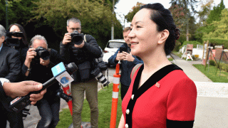In this Oct. 1, 2019, file photo, Huawei Chief Financial Officer, Meng Wanzhou, stops to talk to media while leaving her Vancouver home to appear in British Columbia Supreme Court, in Vancouver.