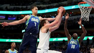 Nikola Jokic #15 of the Denver Nuggets drives to the basket against Dwight Powell #7 of the Dallas Mavericks in the second half at American Airlines Center on Jan. 8, 2020 in Dallas, Texas.
