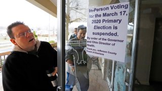 Jefferson County Elections officials arrive to pack up the polling place at Our Lady of Lourdes church in Wintersville, Ohio, March 17, 2020. Ohio's presidential primary was postponed amid coronavirus concerns.