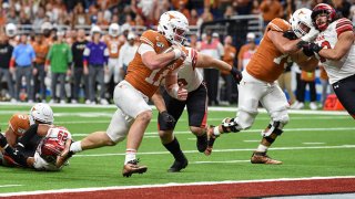 Texas Longhorns quarterback Sam Ehlinger (11) scores a third quarter rushing touchdown during the Alamo Bowl football game between the Utah Utes and Texas Longhorns at the Alamodome on Dec. 31, 2019 in San Antonio, Texas.