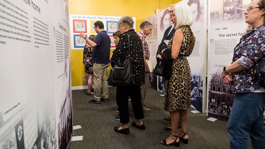 Visitors read about Anne Frank's life in Let Me Be Myself_The Life Story of Anne Frank at the Dallas Holocaust Museum_photo by Amanda Harris