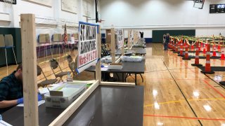 This April 6, 2020 file photo provided by Scott Trindl shows one of the tables, fitted with protective plexiglass, at the sole polling location for city of Waukesha, Wis., residents.