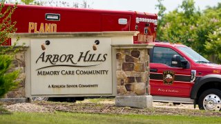 A Plano Fire-Rescue ambulance departs from Arbor Hills Memory Care Community in Plano on Monday. Plano Fire-Rescue officials were at the facility doing COVID-19 testing and discovered at least 17 patients who were symptomatic and needed hospitalization.