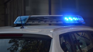 The roof portion of a police car showing flashing lights