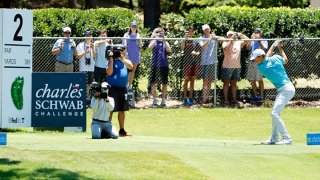 Jordan Spieth of the United States plays his shot from the second tee as fans look on from outside the fence during the third round of the Charles Schwab Challenge on June 13, 2020 at Colonial Country Club in Fort Worth, Texas.