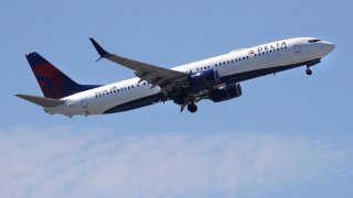 In this May 24, 2018, file photo, a Delta Air Lines passenger jet plane, a Boeing 737-900 model, approaches Logan Airport in Boston.