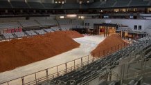 Crews started the daunting task of removing the 16 million pounds of dirt that covered the rodeo floor and the backstage area of Dickies Arena.