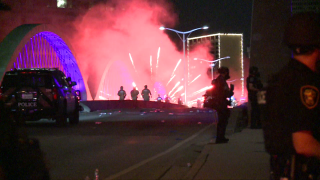 Protesters who were undeterred by tear gas and flashbangs continued to throw frozen water bottles and fire polytechnics towards officers along the West 7th Street Bridge in Fort Worth Sunday night.