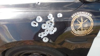 A Fort Worth patrol vehicle parked roadside received a hail of bullets.