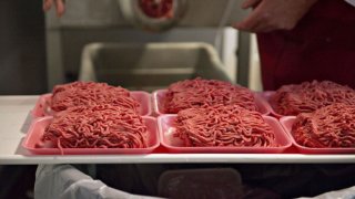 FILE -Ground beef is portioned onto trays in the meat department of a supermarket in Illinois, on Wednesday, July 2, 2014. Saturday, the USDA issued a recall notice for ground beef products shipped to stores across the country.