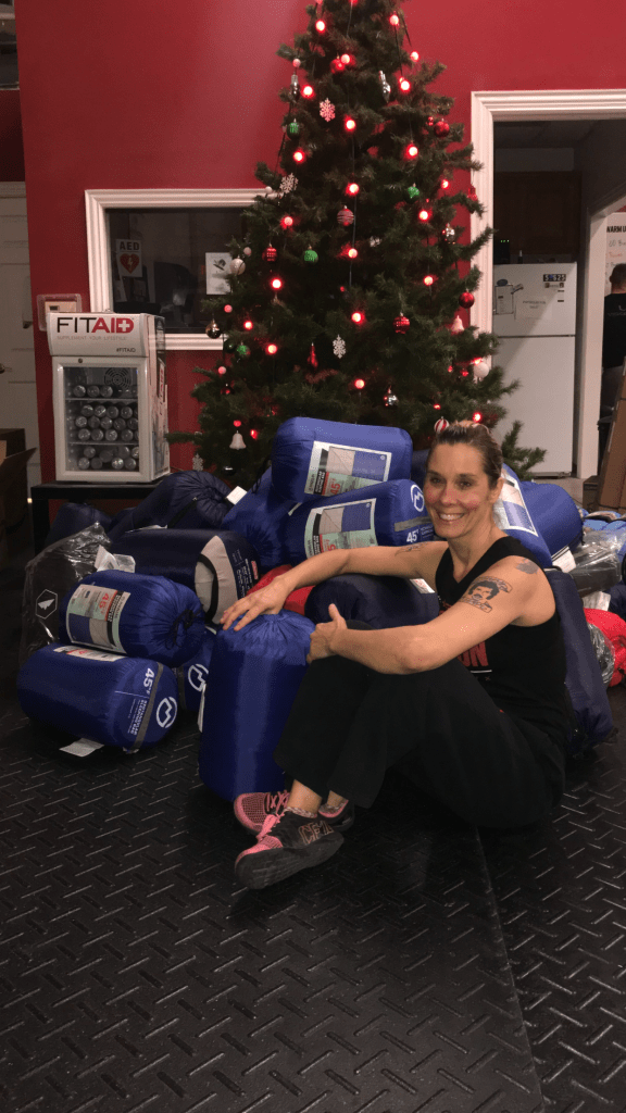 Christy Woods with the sleeping bags she's collected for the homeless.