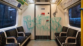 This undated photo issued on Tuesday July 14, 2020 by JBPR, shows Banksy's latest work sprayed on the inside of a London Underground tube carriage. Enigmatic graffiti artist Banksy uploaded a video to social media on Tuesday of what appeared to be him in disguise as a professional cleaner spray painting images of rats on the inside of a London Underground train along with messages about spreading the new coronavirus.