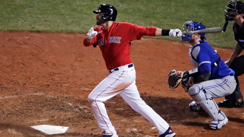 Boston Red Sox's J.D. Martinez watches the flight of his two-run home run during the fifth inning of an exhibition baseball game against the Toronto Blue Jays, Tuesday, July 21, 2020, at Fenway Park in Boston.